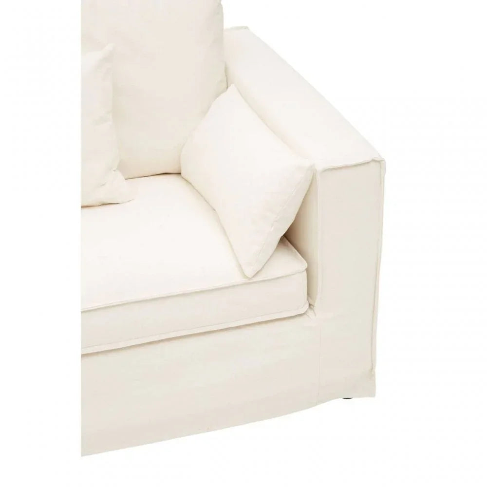 Cream fabric sofa corner with armrest and scatter cushions