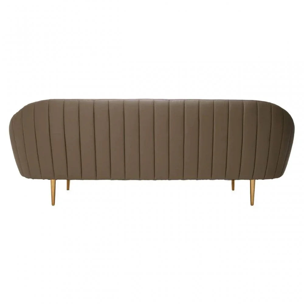Brown upholstered sofa back with vertical stitching and gold metal legs