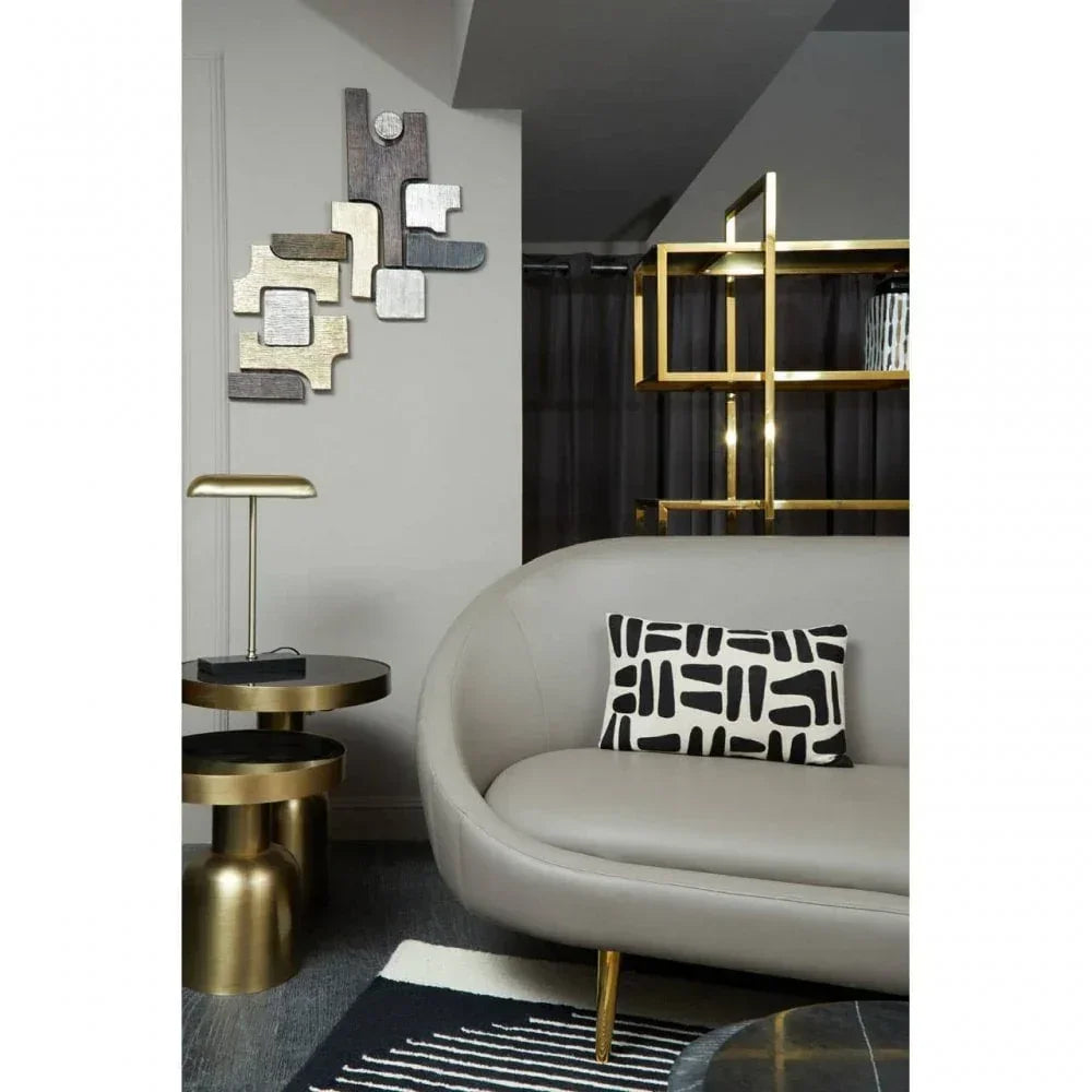 Modern living room with grey sofa, black and white cushion, gold side table and wall art
