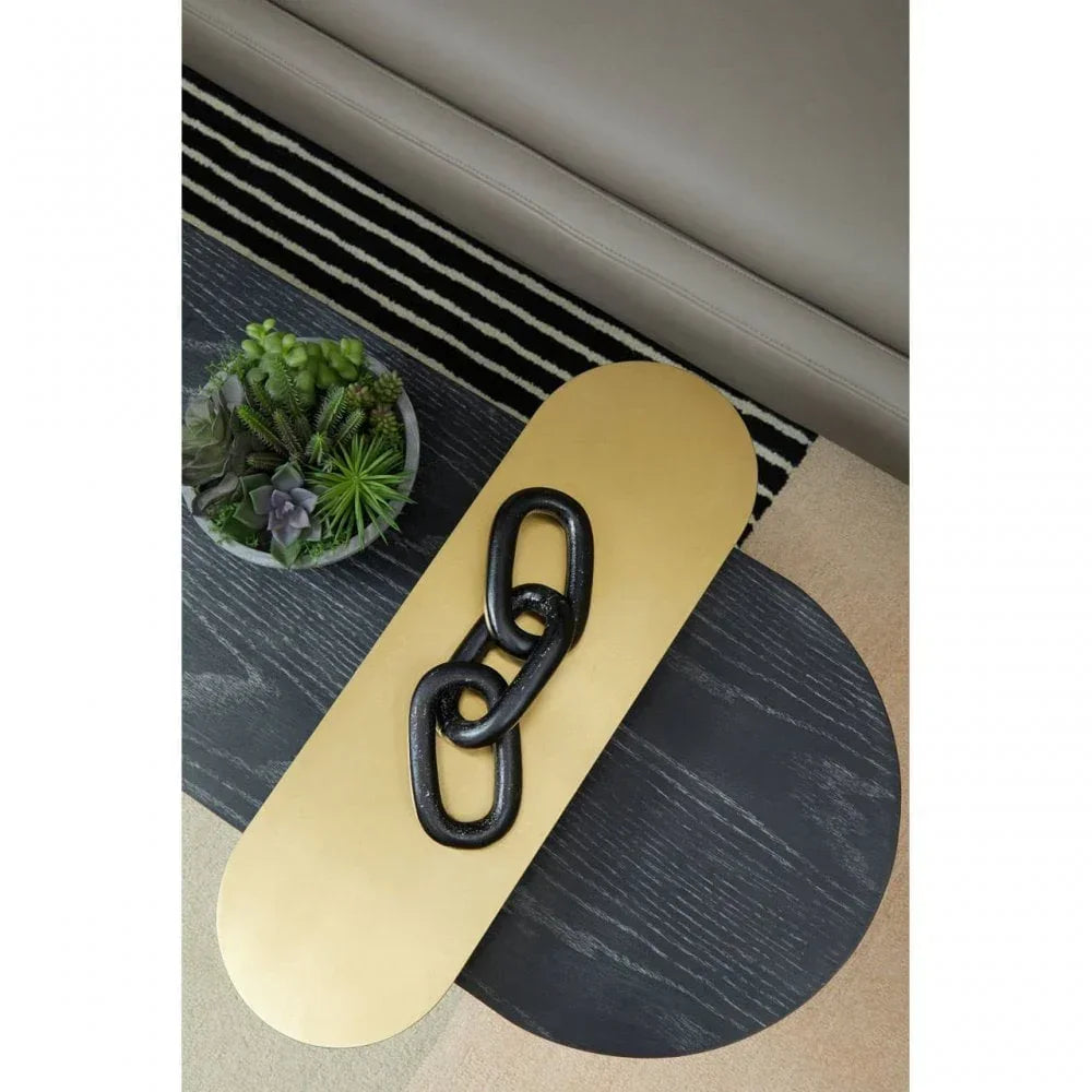 Black wooden coffee table with gold tray, decorative chain and succulent plant arrangement