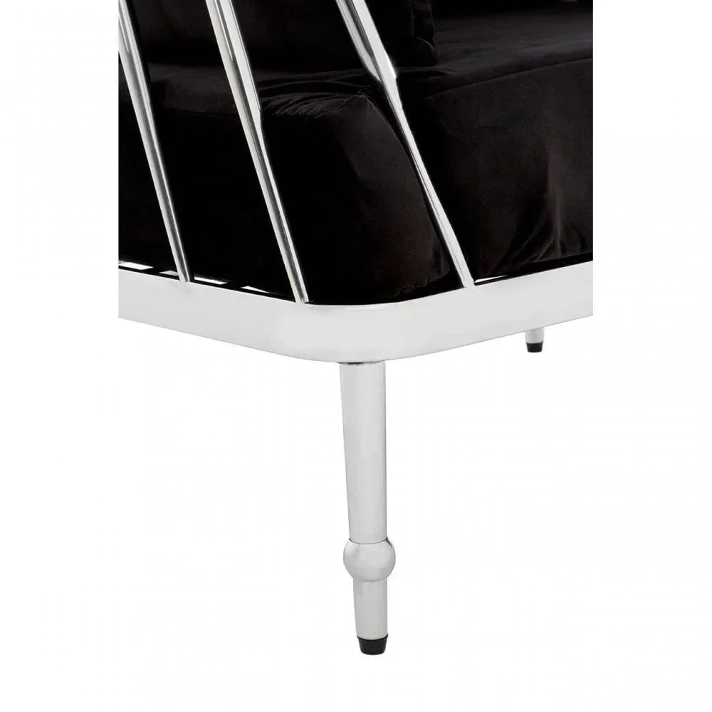 Chrome sofa leg with vertical bars and black velvet seat cushion closeup