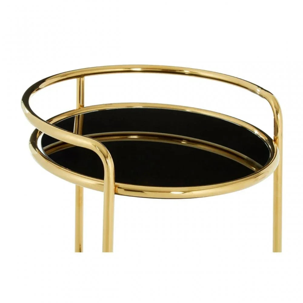 Round gold metal side table with black glass top, modern design close view
