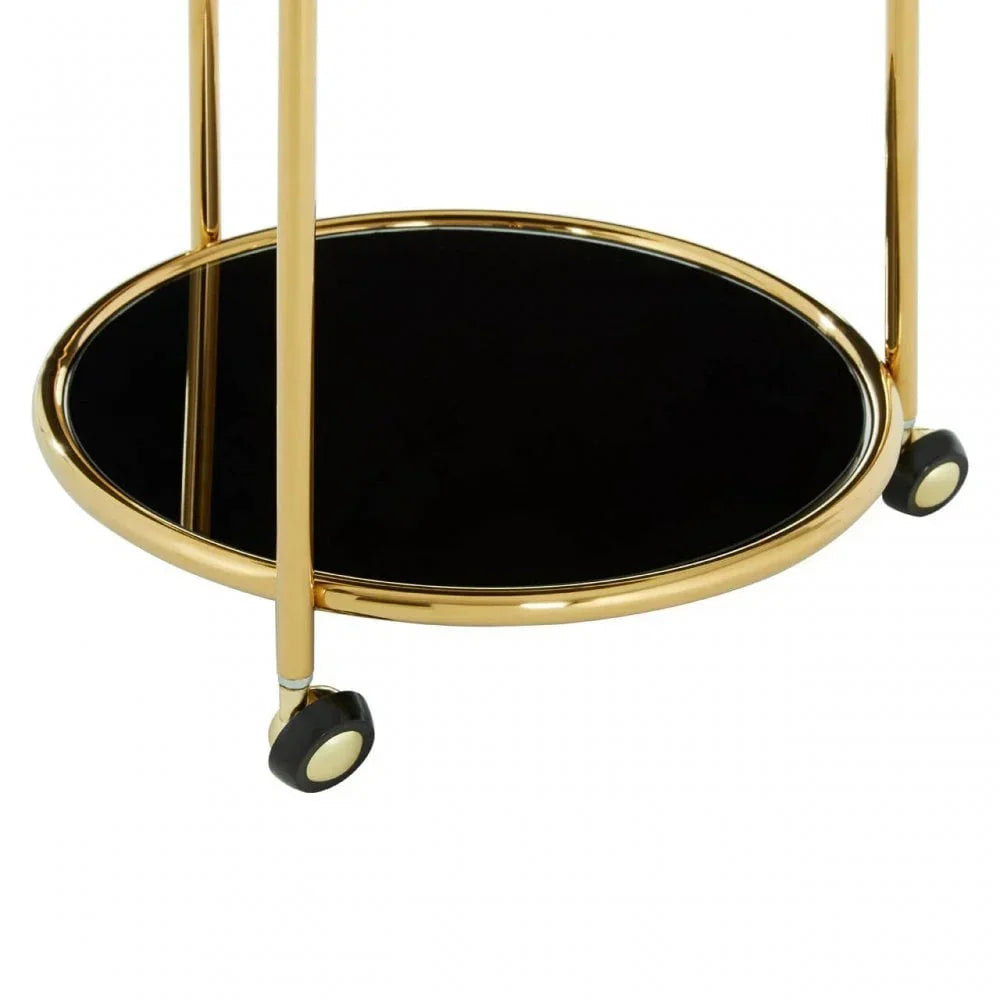 Round gold drinks trolley with black glass shelf and caster wheels closeup