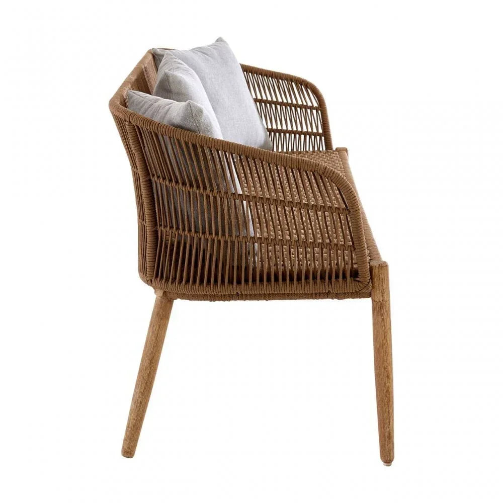 Side view of rattan armchair with wooden legs and two grey seat cushions