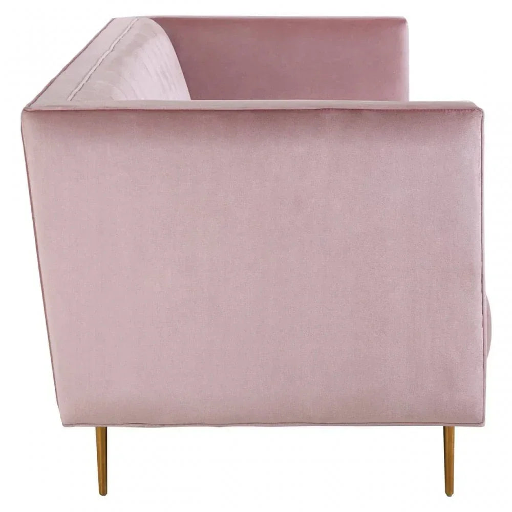 Blush pink velvet sofa with gold legs, side profile view