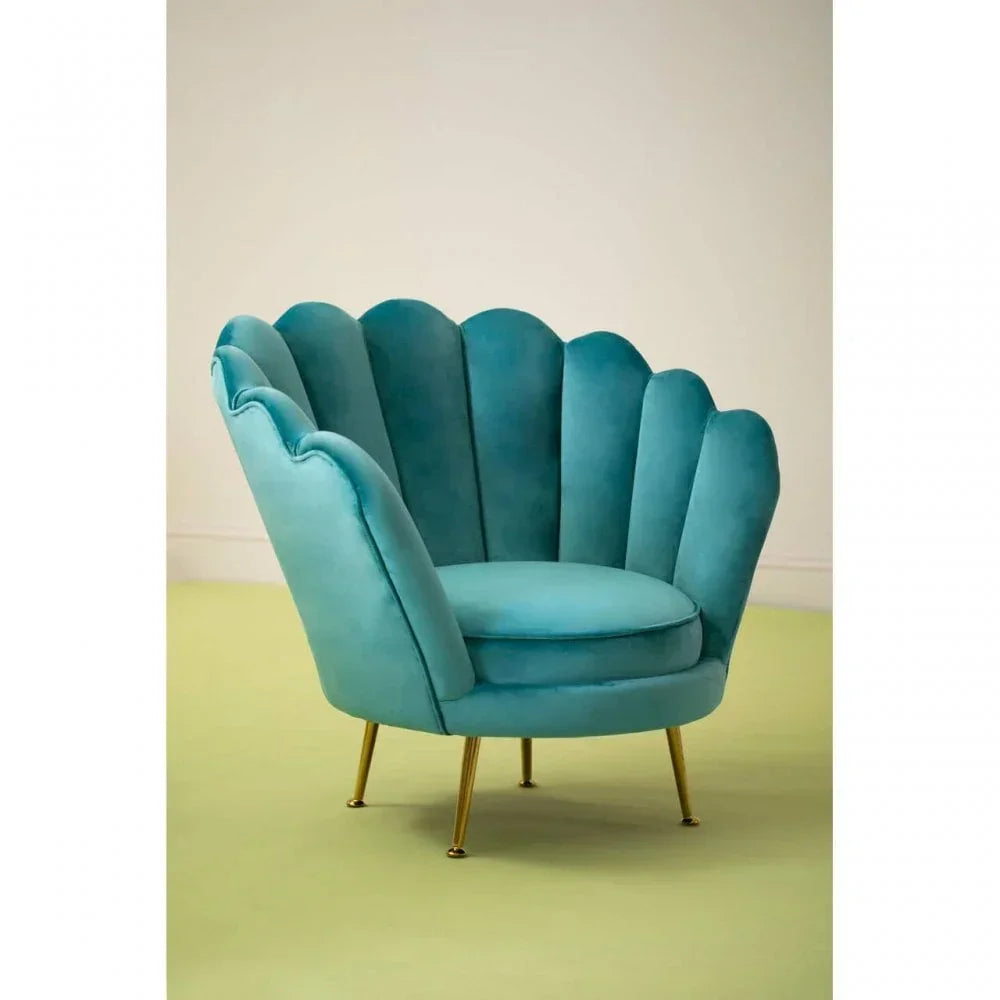 Teal velvet accent chair with scalloped back and gold legs in a minimalist room