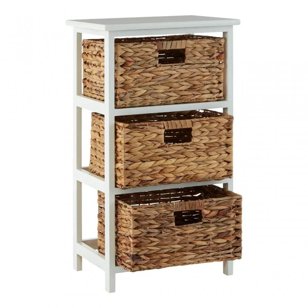 White wooden storage unit with three woven rattan drawers shown at an angle