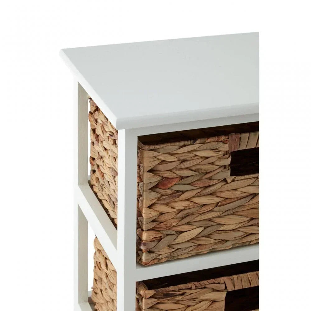 White wooden storage unit with woven basket drawers, close-up corner view