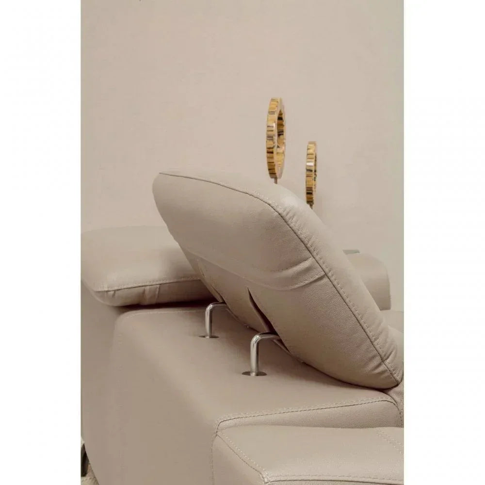 Beige leather sofa with adjustable headrest and chrome supports, side view