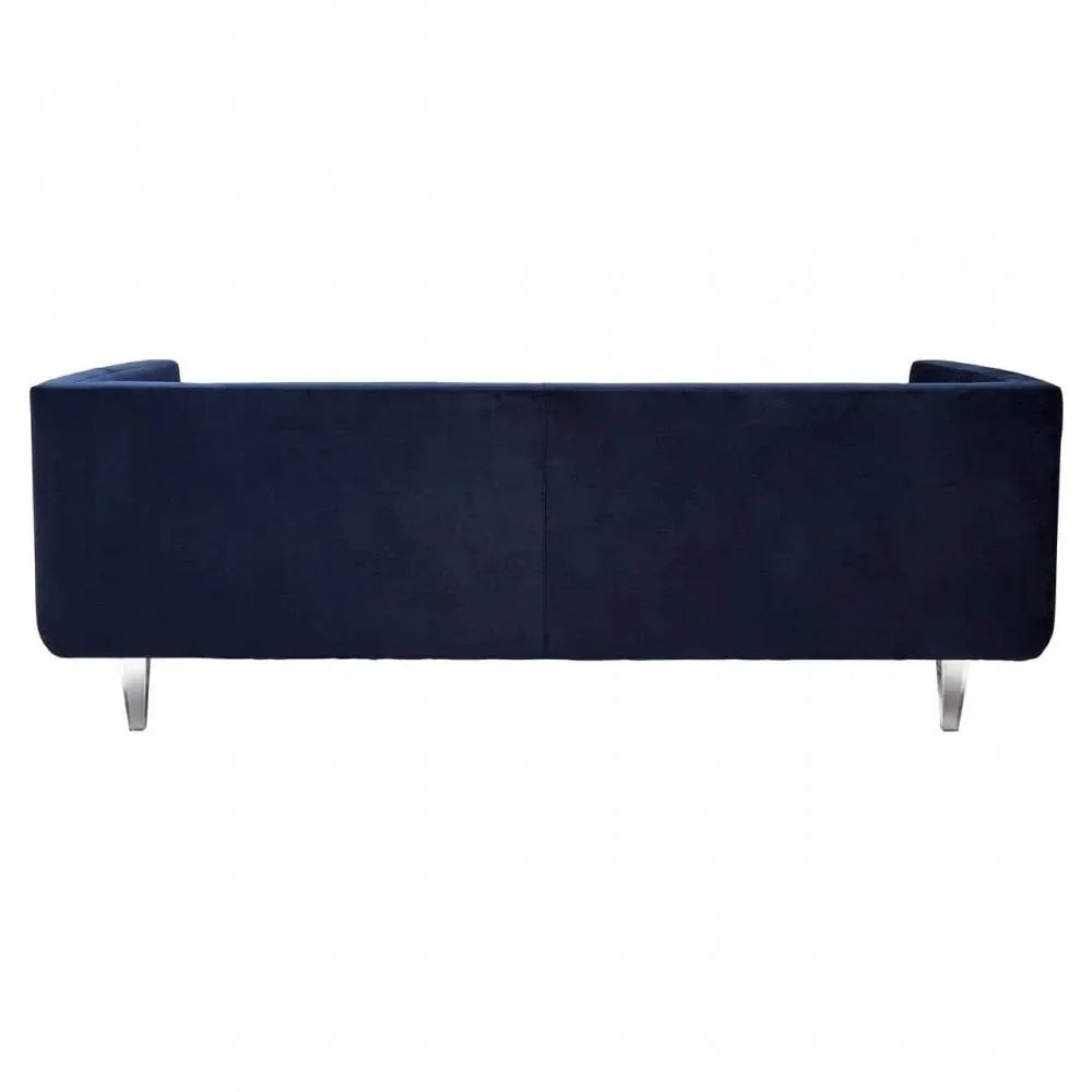 Rear view of navy blue velvet sofa with chrome legs on white background