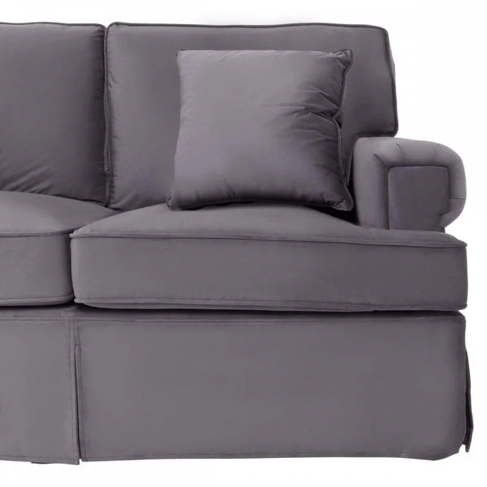 Grey fabric sofa with matching cushion, featuring wide armrest and deep seat close-up