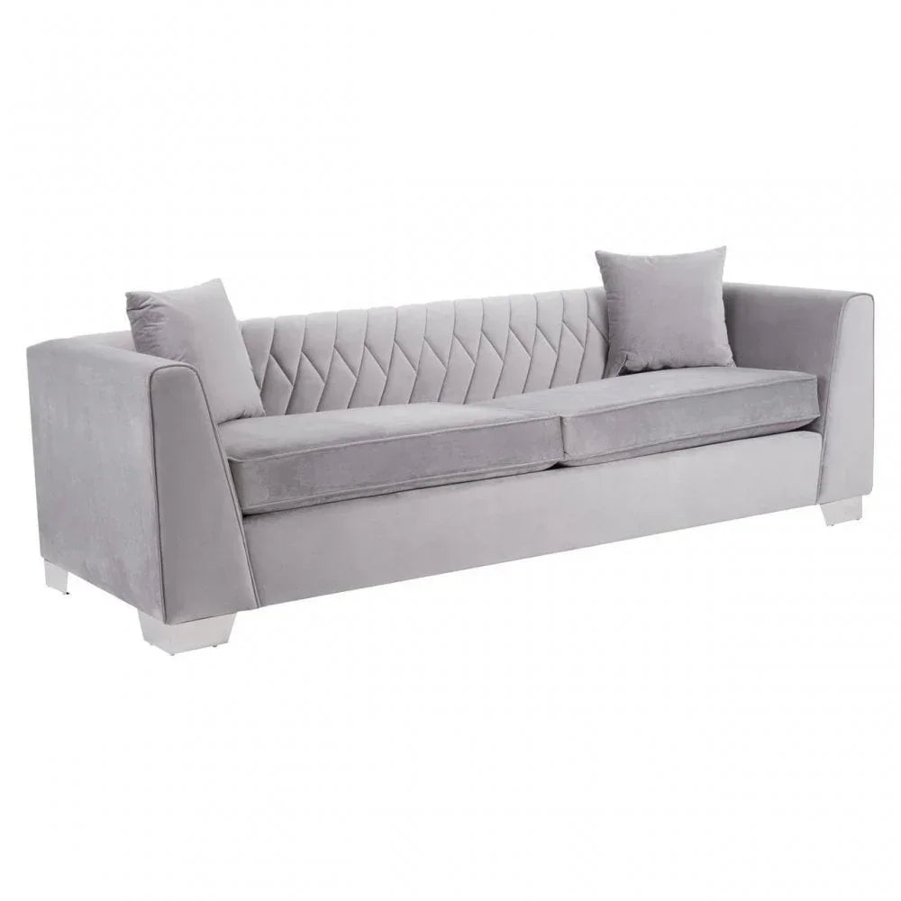 Grey velvet sofa with quilted backrest and two matching scatter cushions
