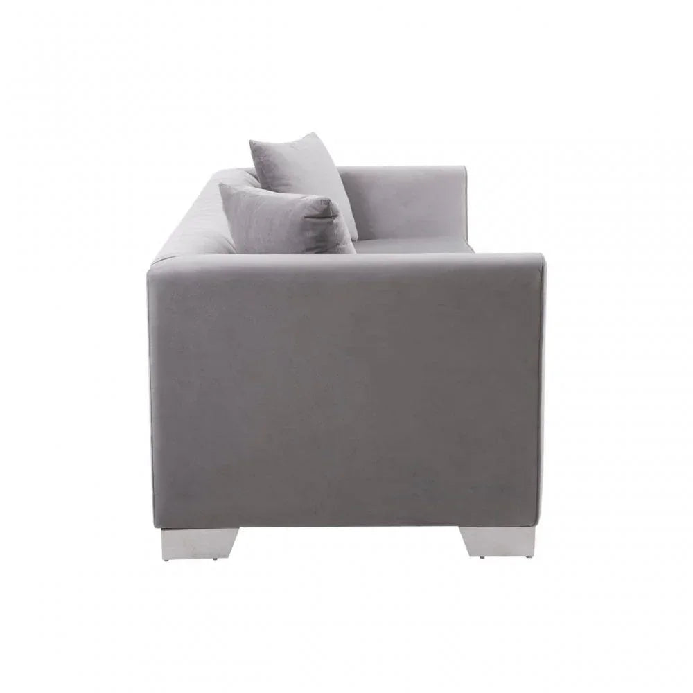 Side view of modern grey fabric sofa with chrome legs and two matching cushions