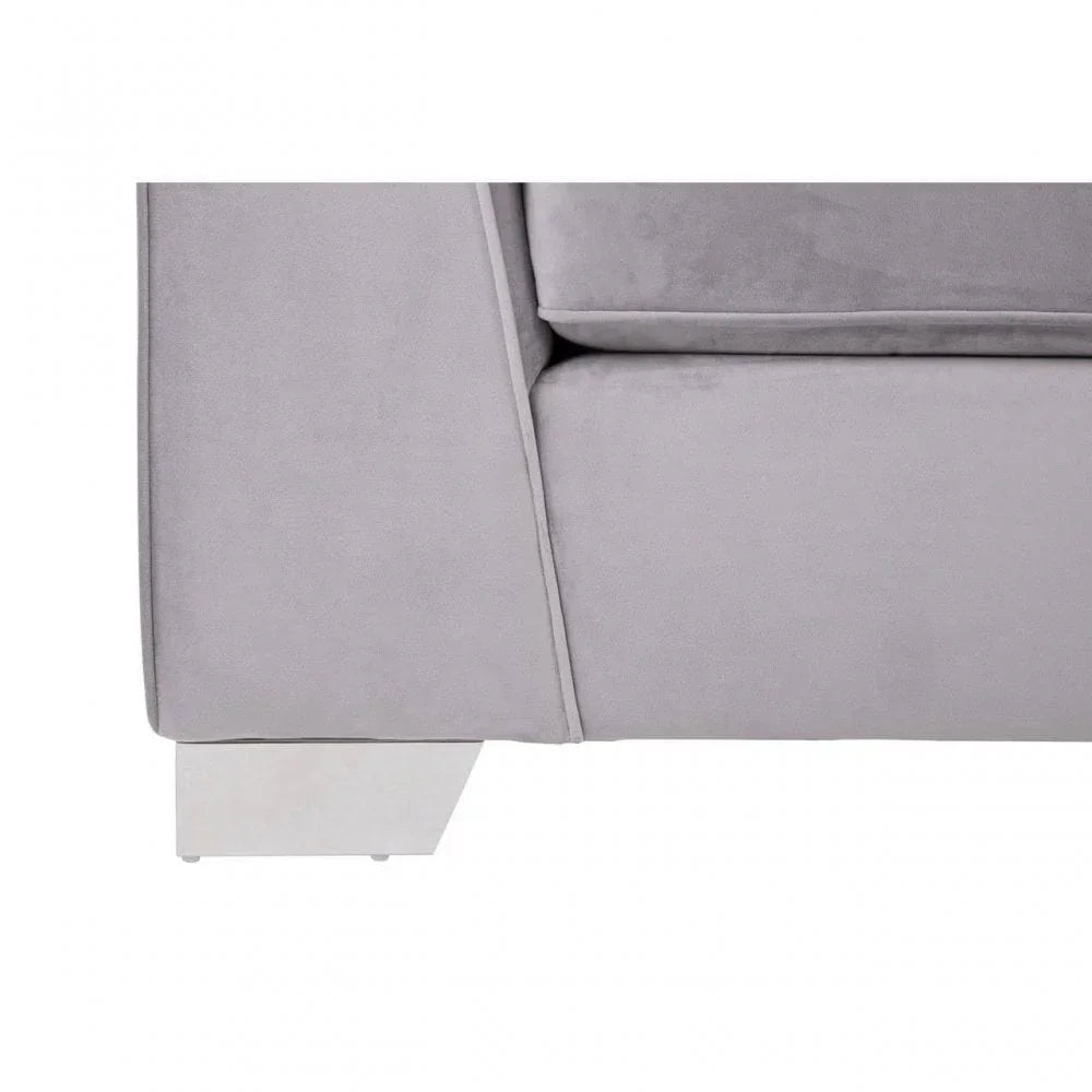 Closeup of grey fabric sofa arm and cushion with silver metal leg