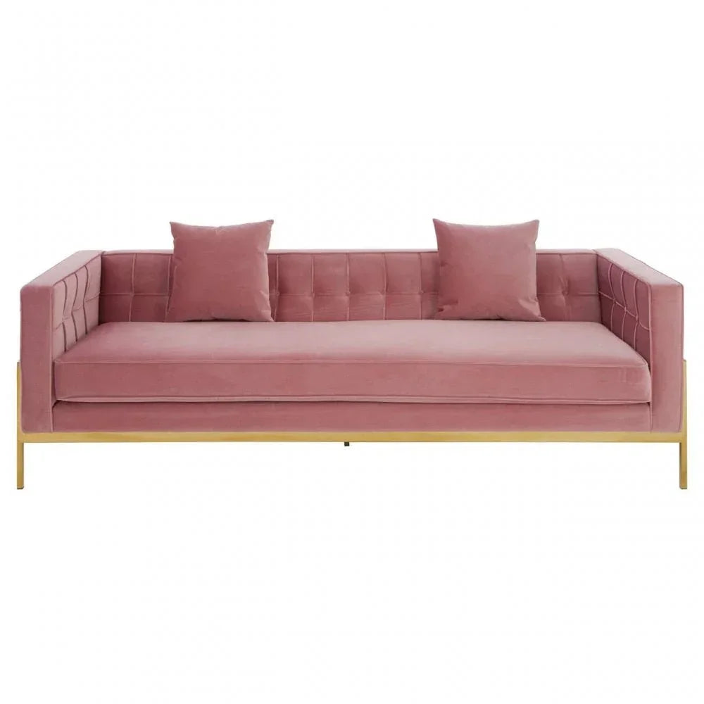 Pink velvet sofa with two matching cushions and gold metal base, front view