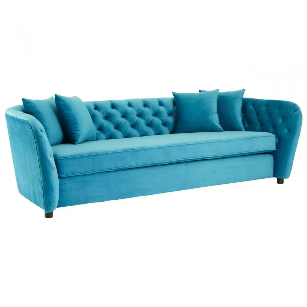 Blue velvet sofa with tufted backrest and three matching scatter cushions, front angle view