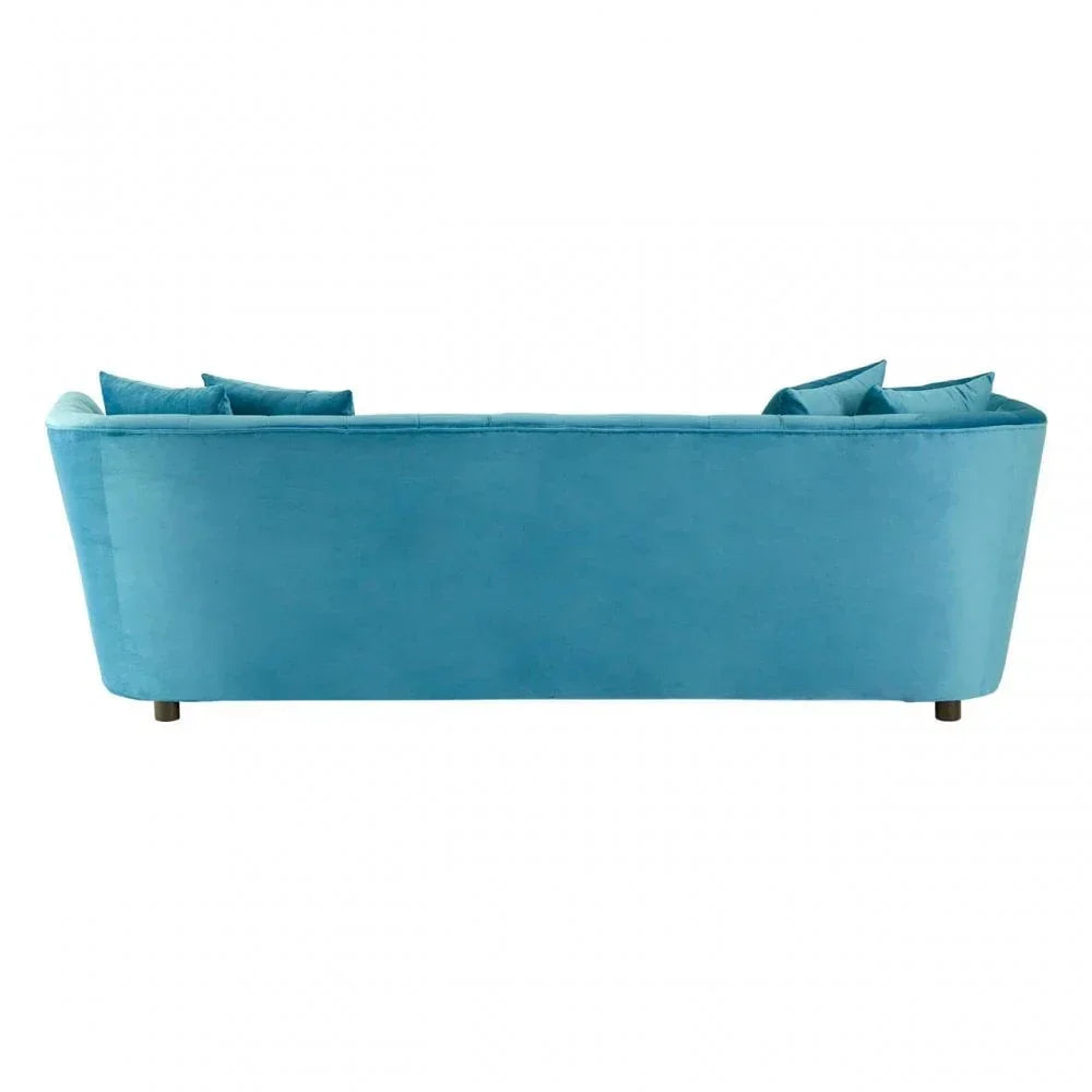 Back view of teal velvet sofa with angled arms and matching throw cushions