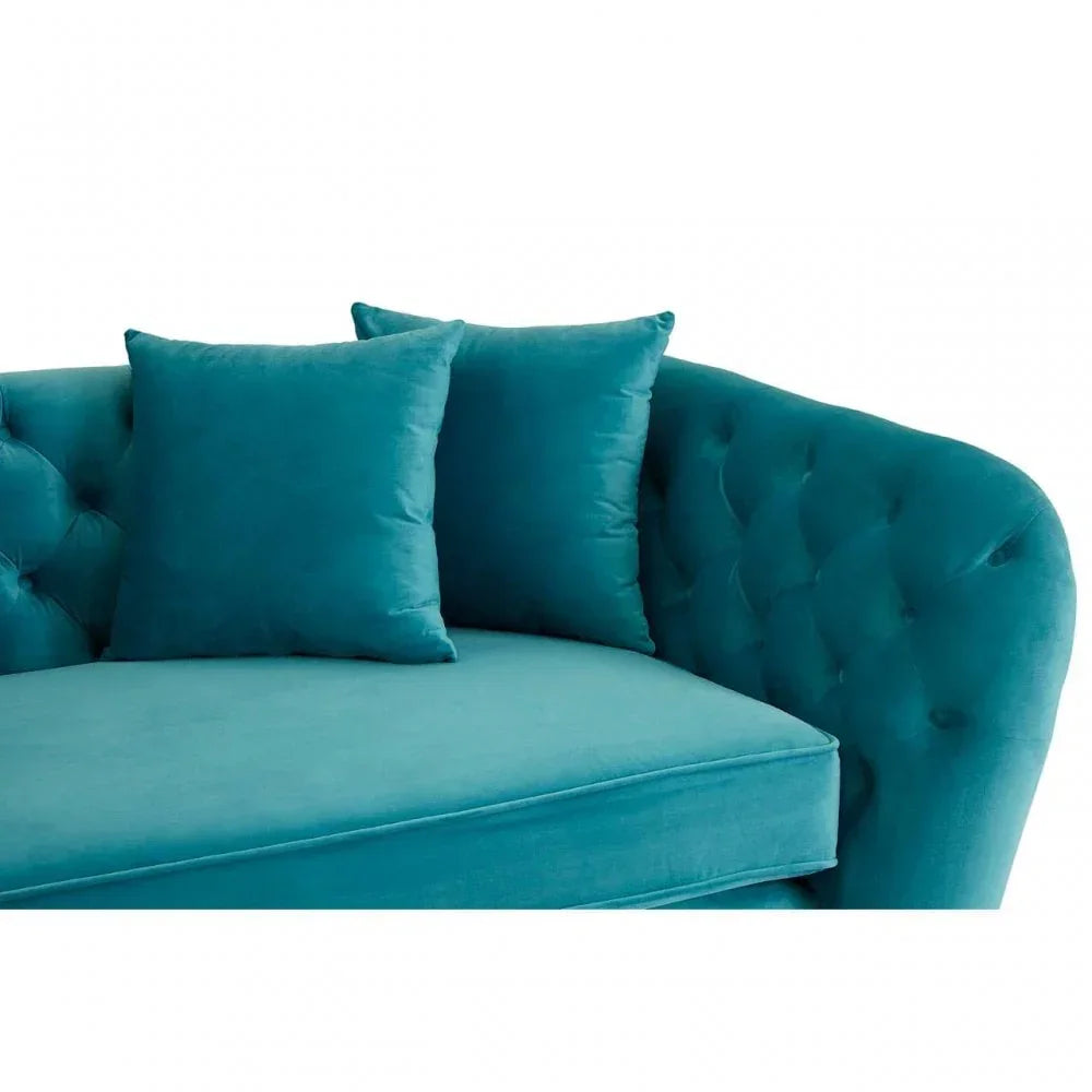 Teal velvet sofa with button-tufted back and two matching square cushions