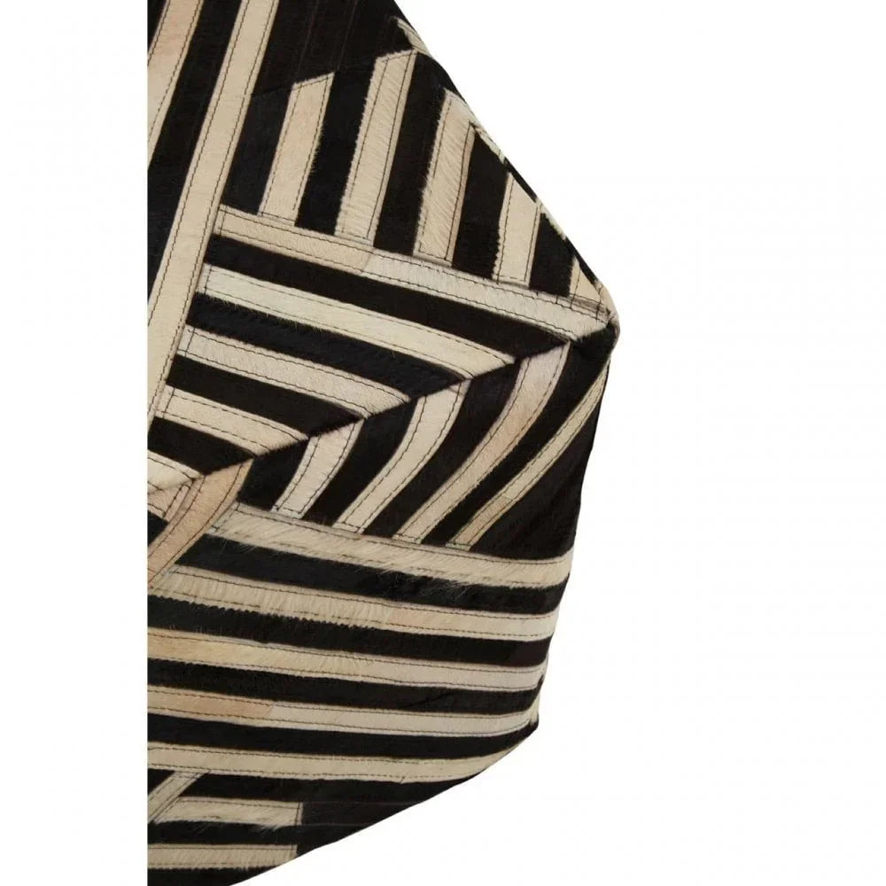 Black and beige geometric patterned cushion with stitched hide detail, close view