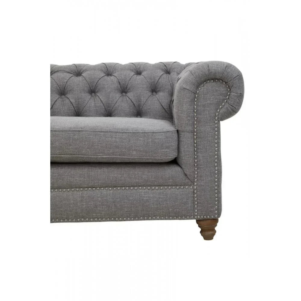 Tufted grey fabric Chesterfield sofa arm with nailhead trim and wooden leg