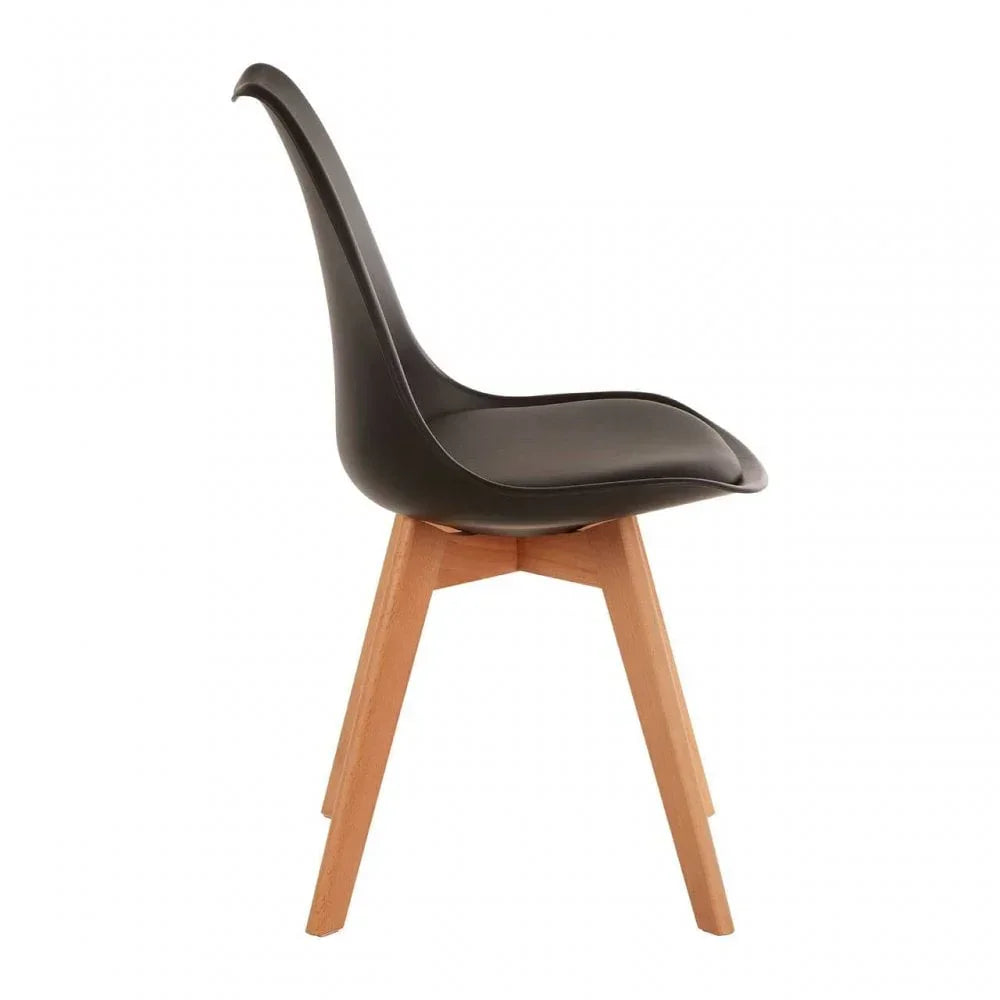 Black dining chair with curved plastic seat and light wood legs, side view