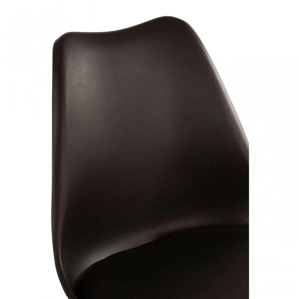 Close-up of black dining chair curved plastic backrest