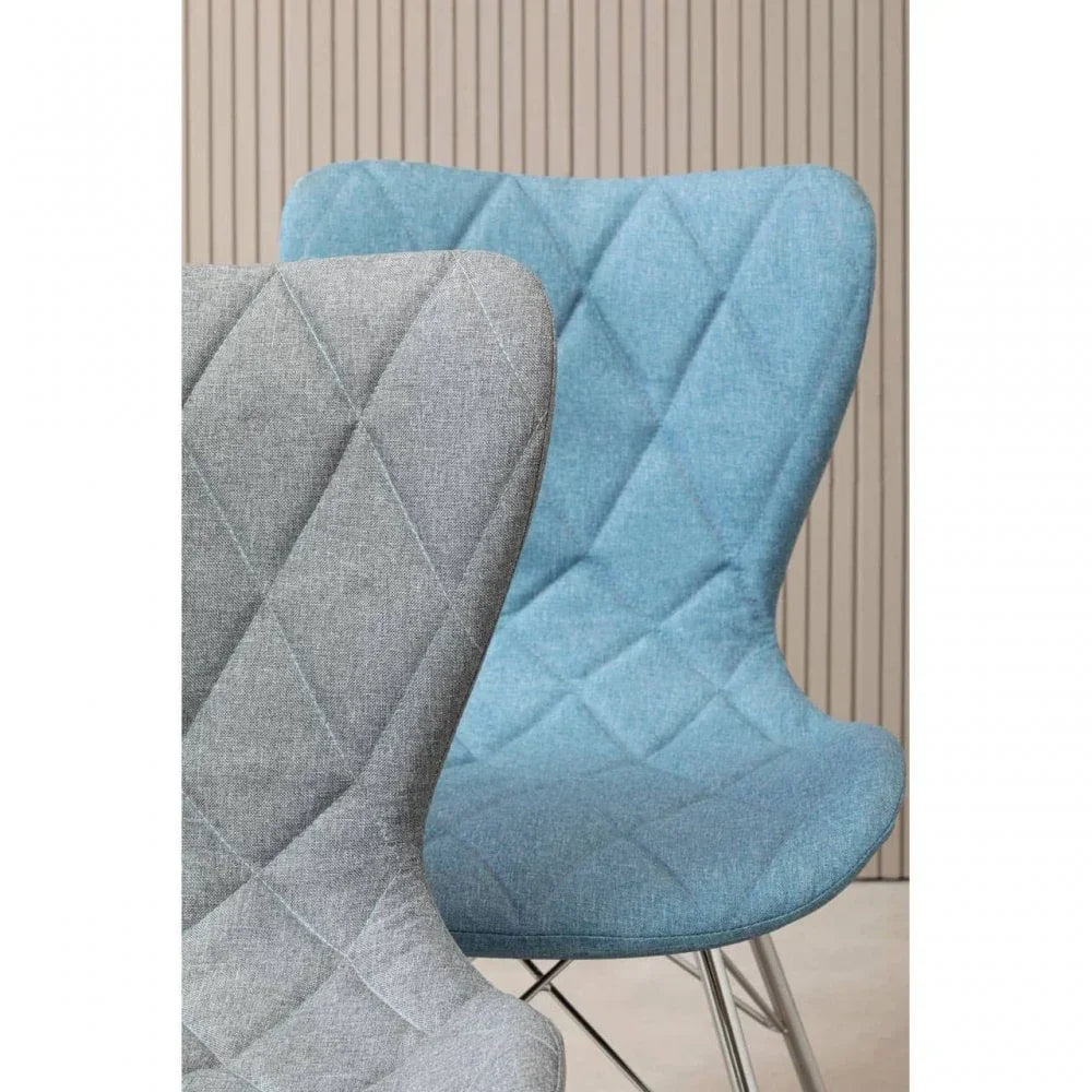 Grey and blue fabric dining chairs with diamond stitching, angled metal legs, close up
