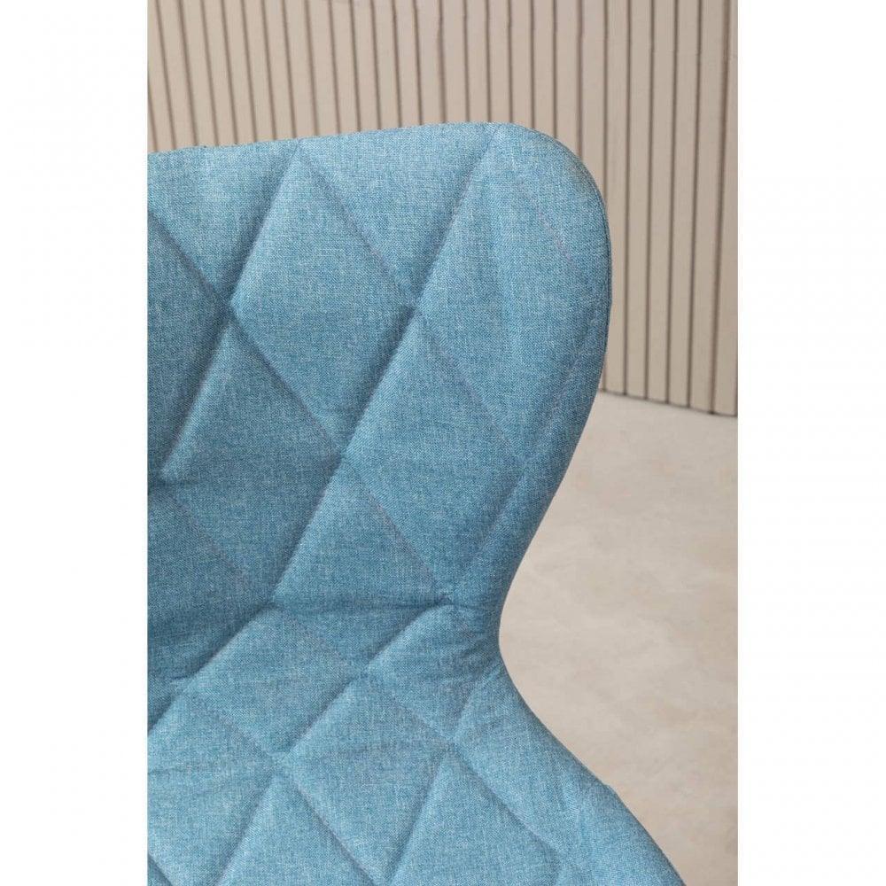 Blue fabric dining chair with diamond stitched backrest, close-up view