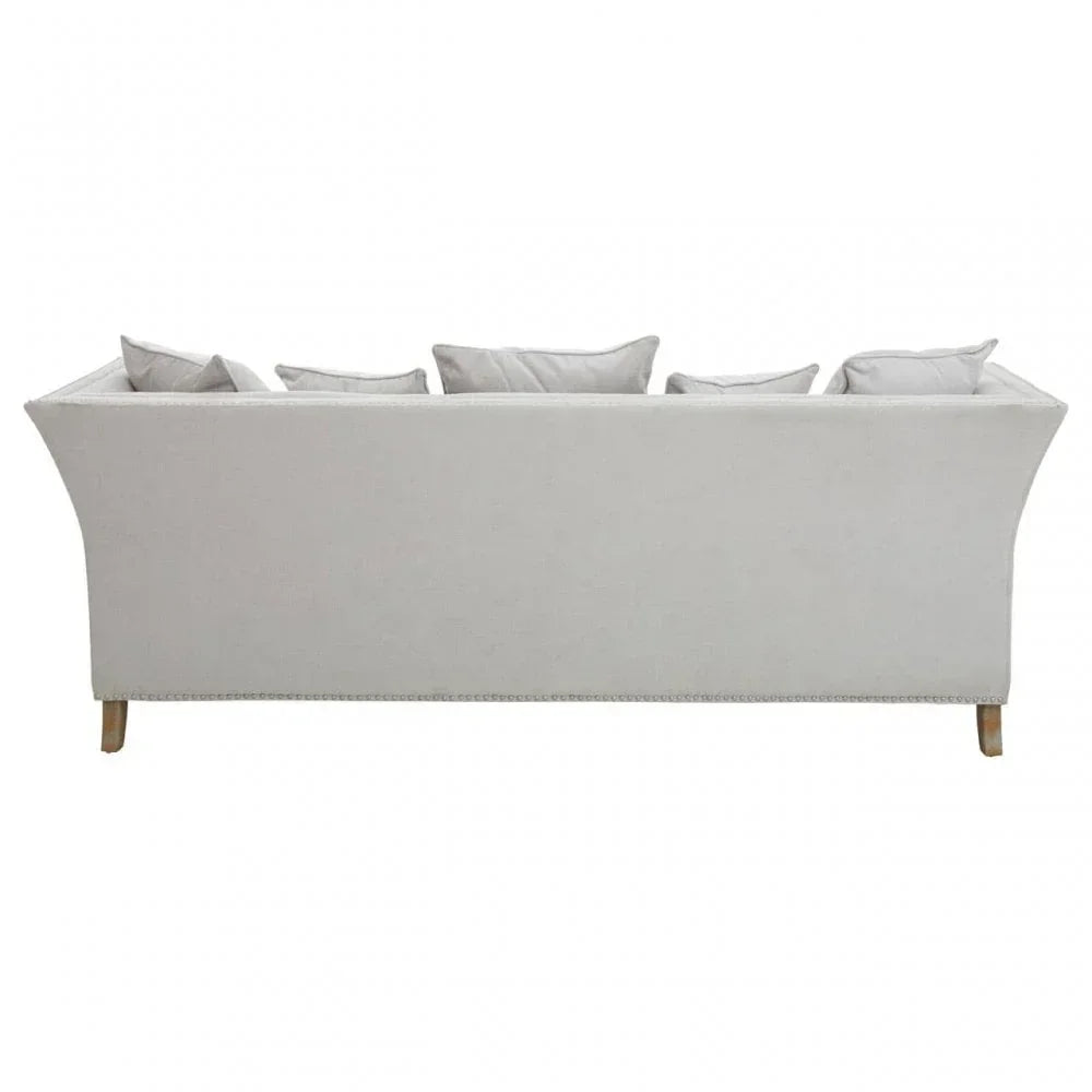 Rear view of light grey fabric sofa with wooden legs and multiple back cushions