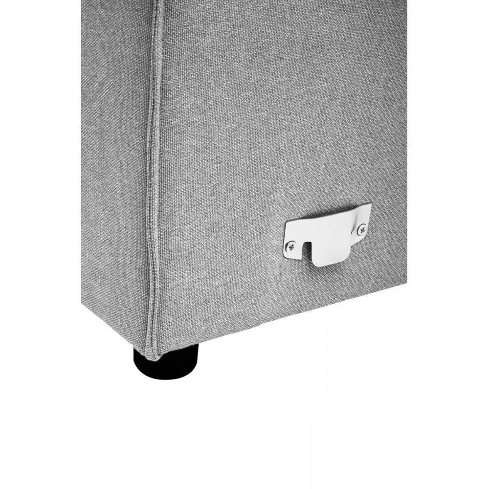 Grey fabric sofa corner with visible metal connector and black leg