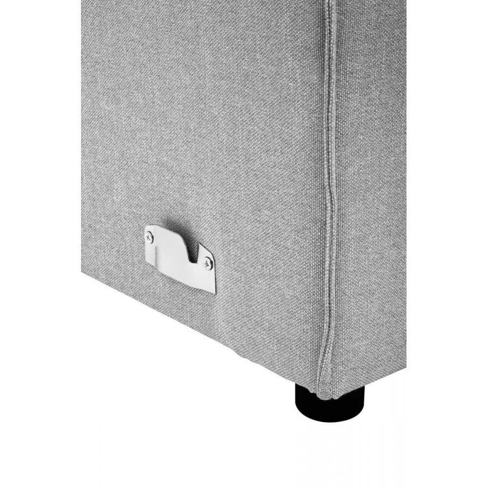 Closeup of light grey fabric sofa corner with metal bottle opener and black leg