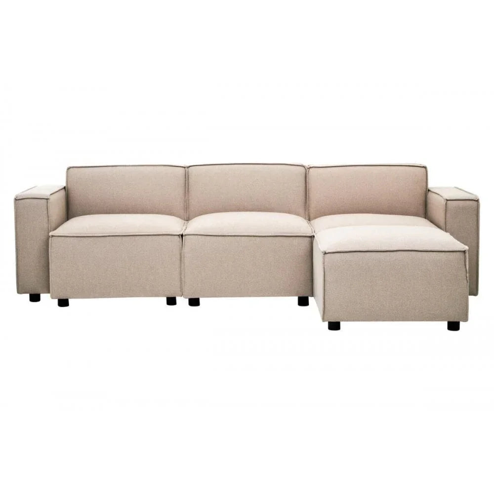 Beige corner sofa with boxy armrests and chaise lounge section on black legs