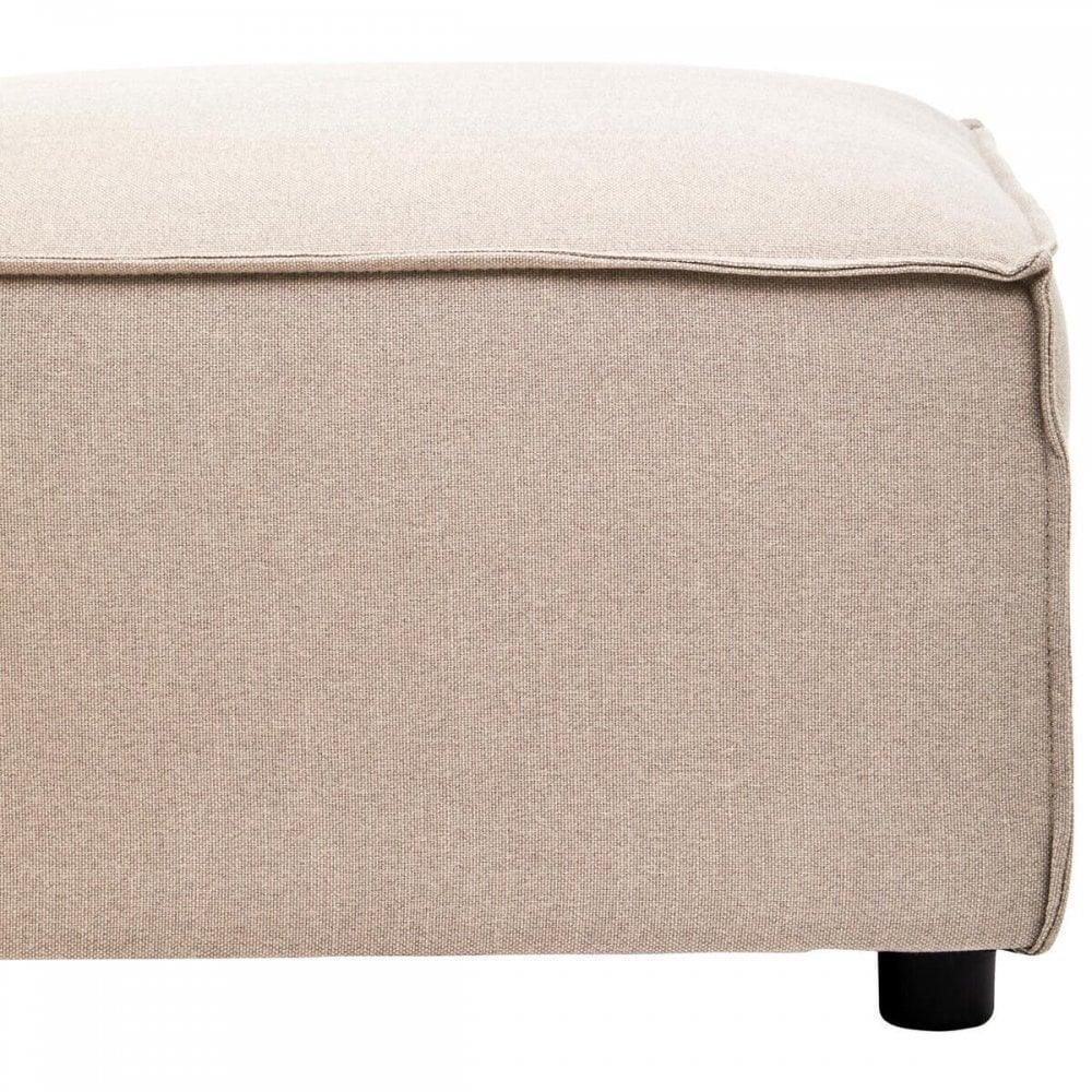 Beige fabric ottoman footstool with visible stitching, close-up of corner and black leg
