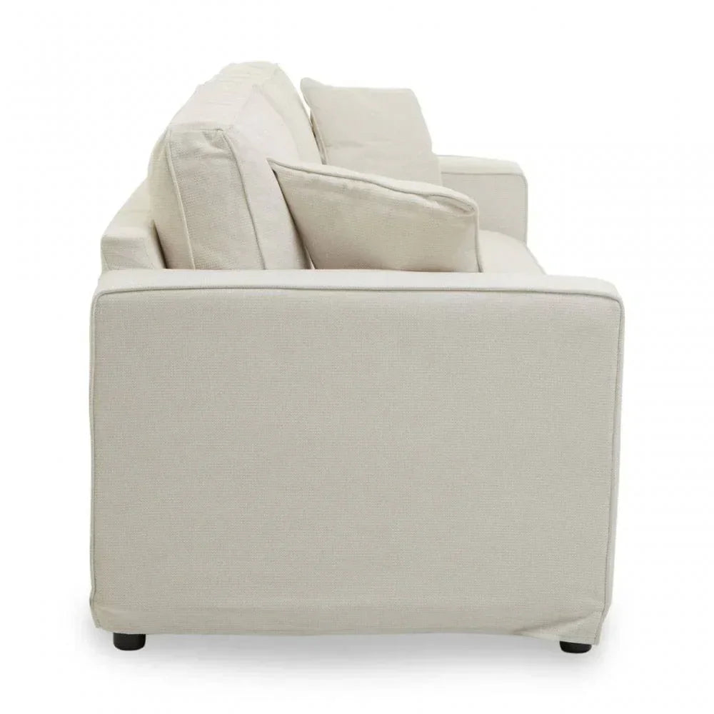 Side view of cream fabric sofa with square armrest and matching cushions