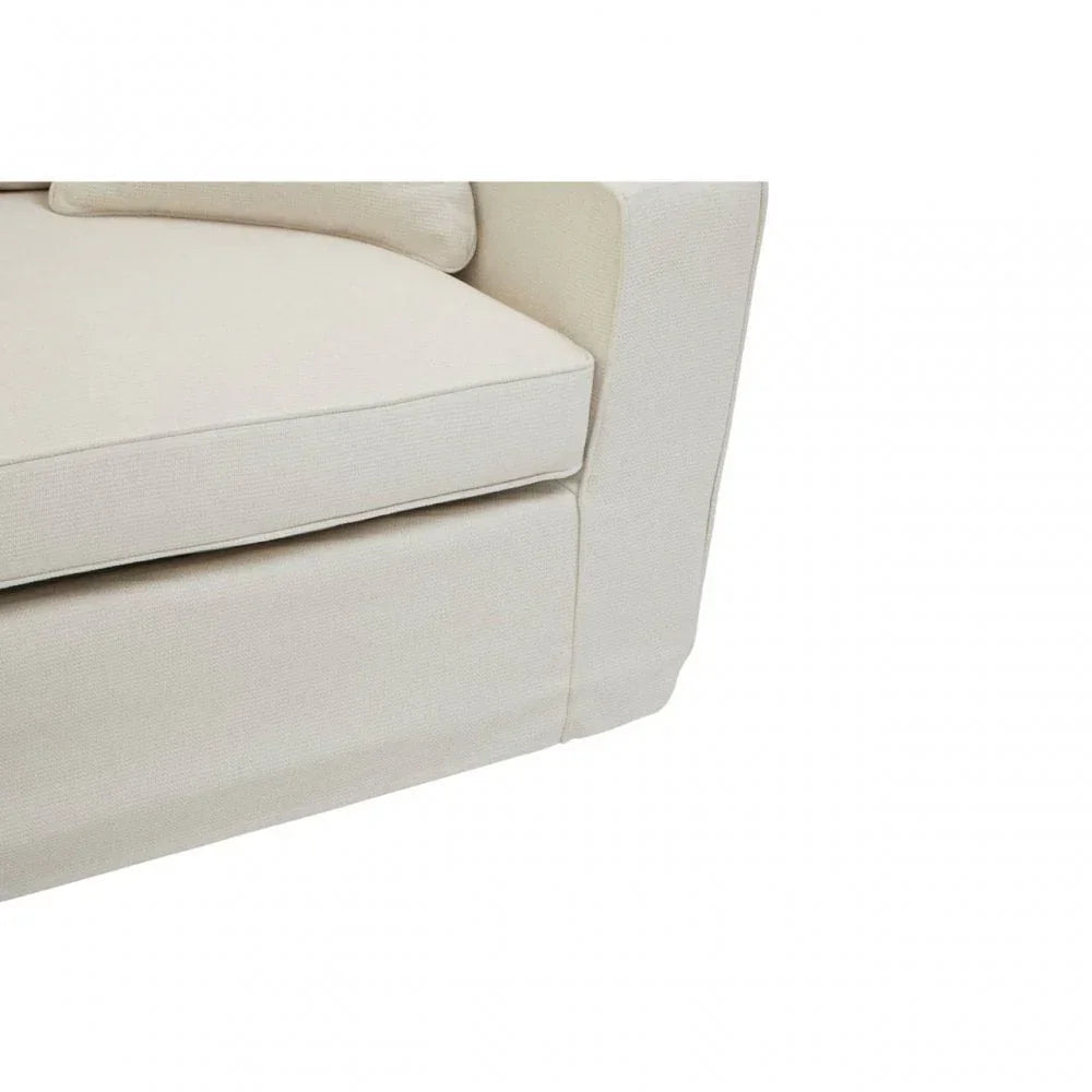 Beige fabric sofa corner with seat cushion and pillow detail