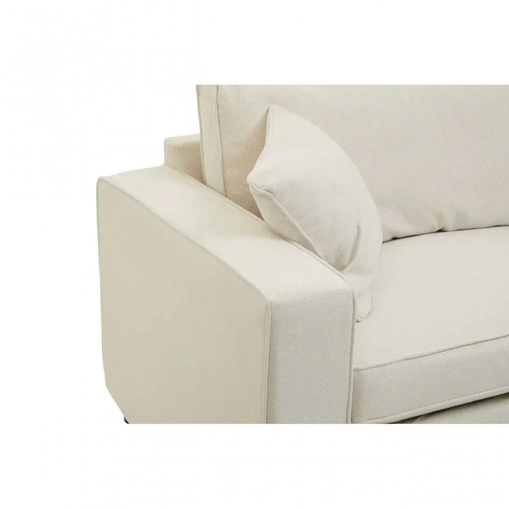 Beige fabric sofa arm with back cushion and matching scatter cushion close-up