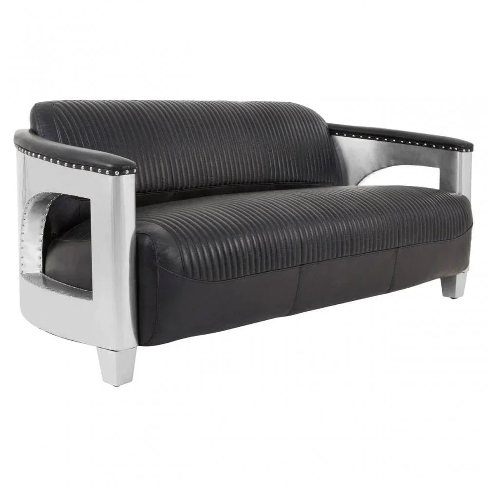Black leather sofa with ribbed upholstery and silver metal armrests, angled front view