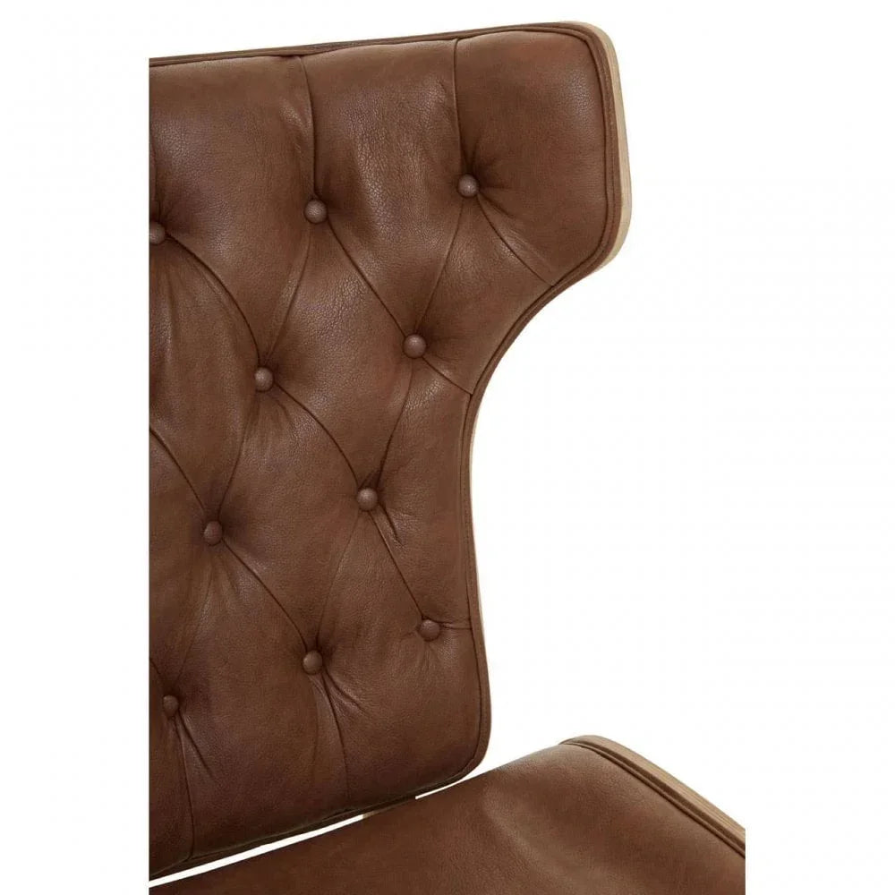 Brown leather armchair backrest with tufted button detailing close up