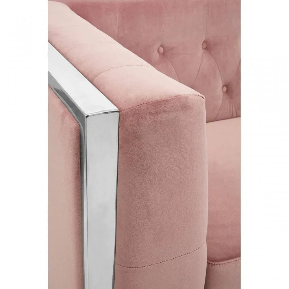 Pink velvet sofa arm with chrome metal frame and button-tufted backrest detail