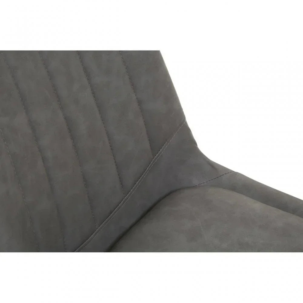 Close up of grey upholstered dining chair with vertical stitching on backrest