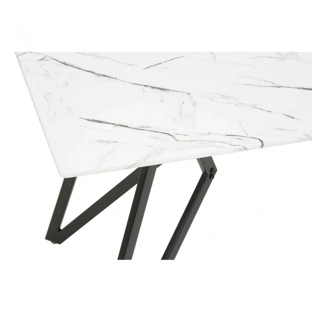 Rectangular white marble dining table with black metal legs, close-up of corner