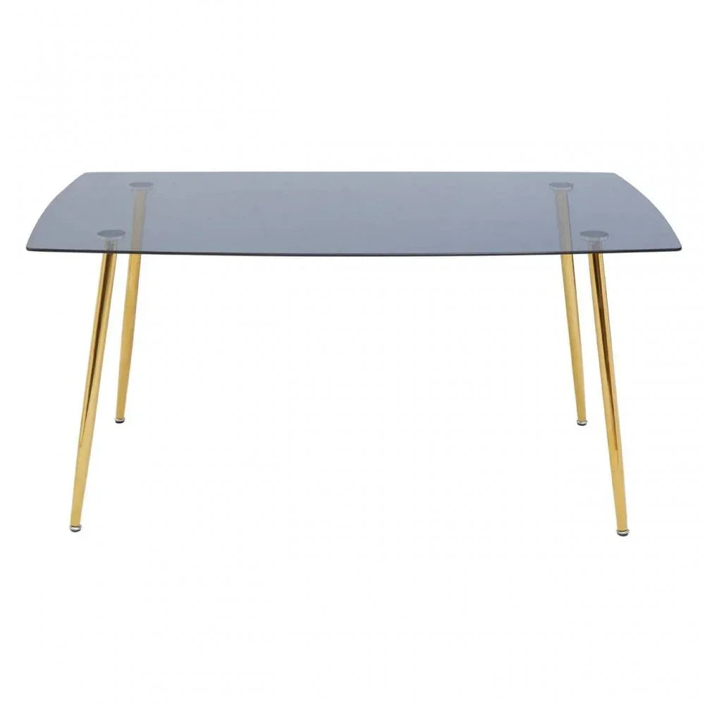 Rectangular glass dining table with gold metal legs on white background
