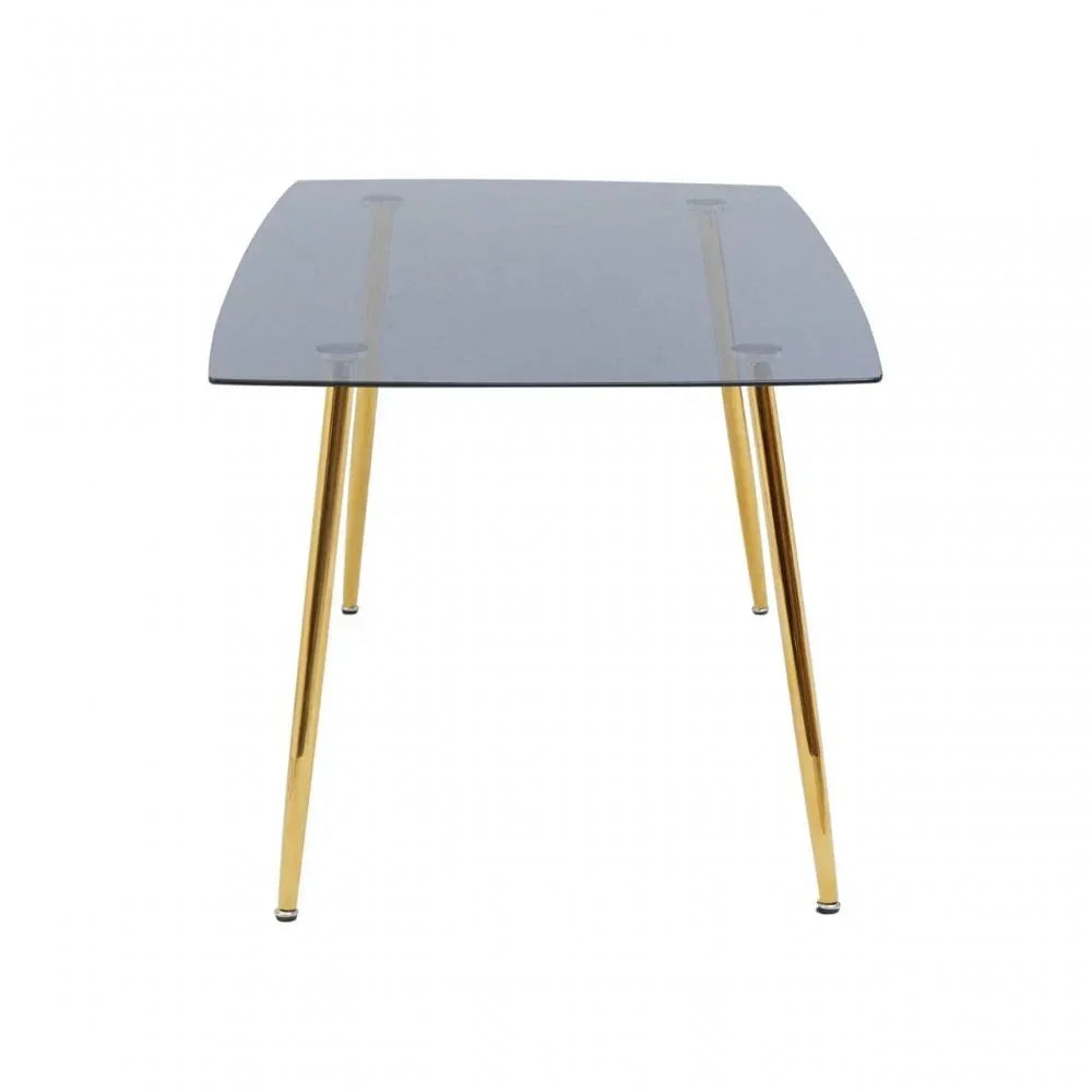 Glass dining table with gold legs, viewed from front, modern minimalist design