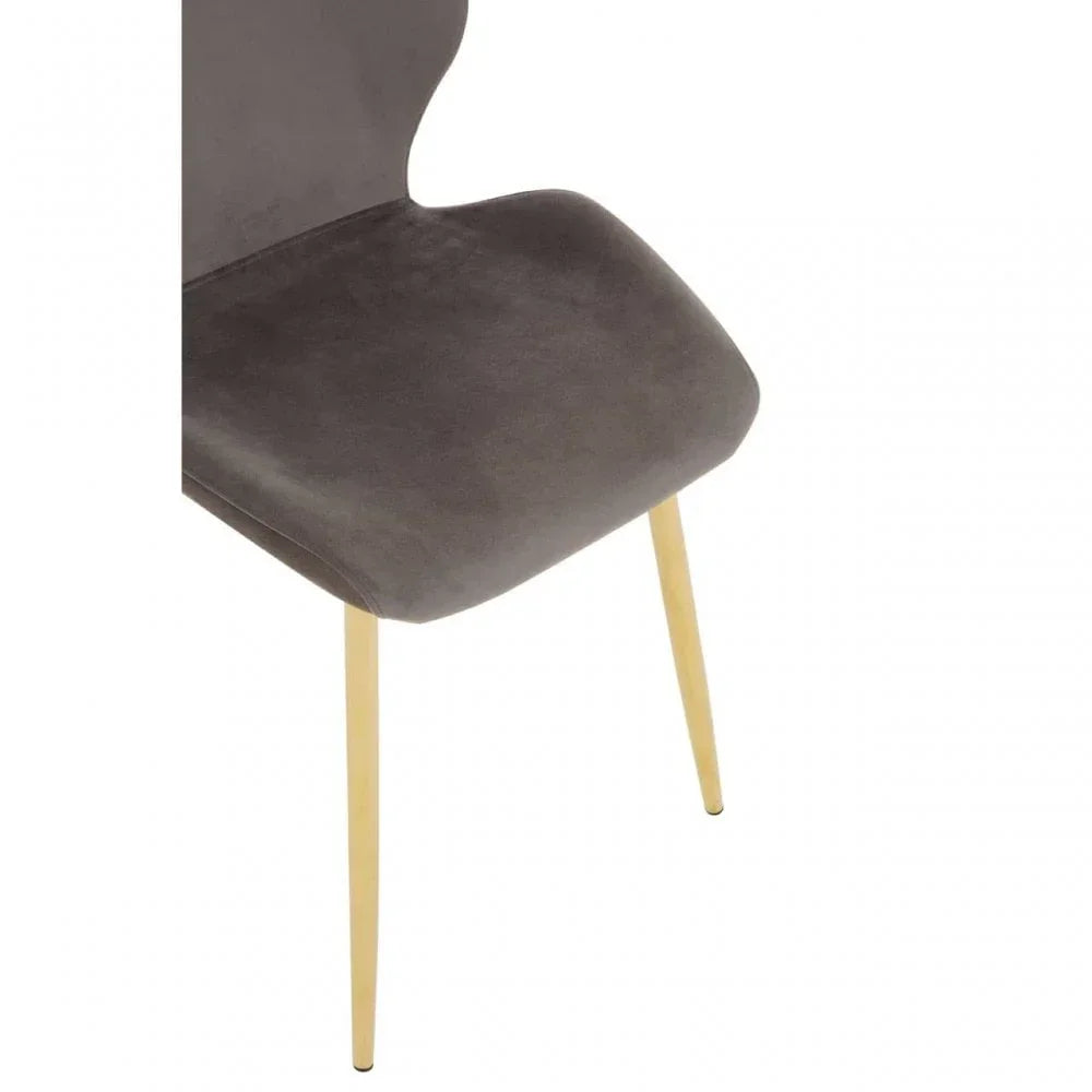 Grey velvet dining chair with gold metal legs, close up of seat and partial backrest