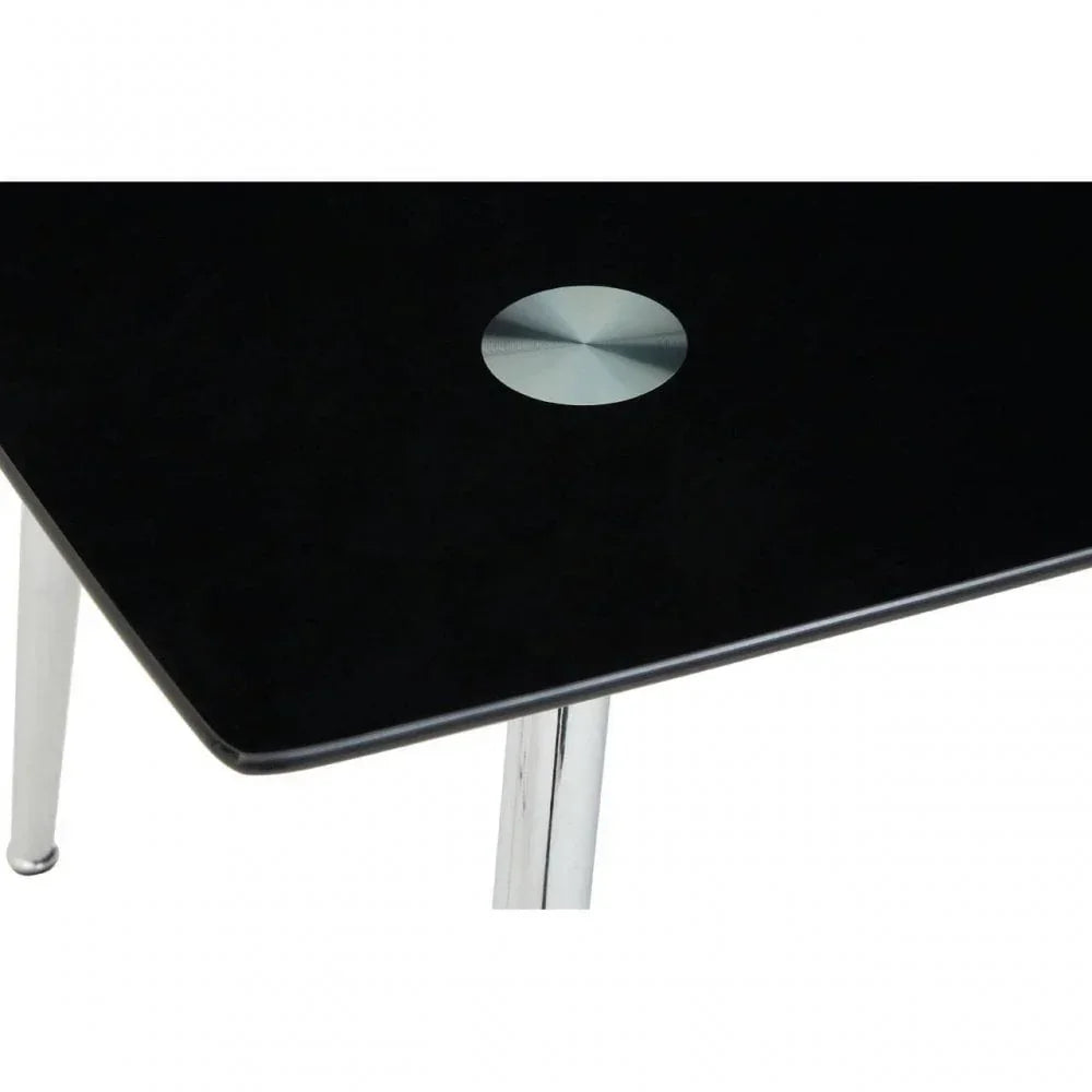 Close-up of black glass dining table corner with chrome legs and circular metal detail