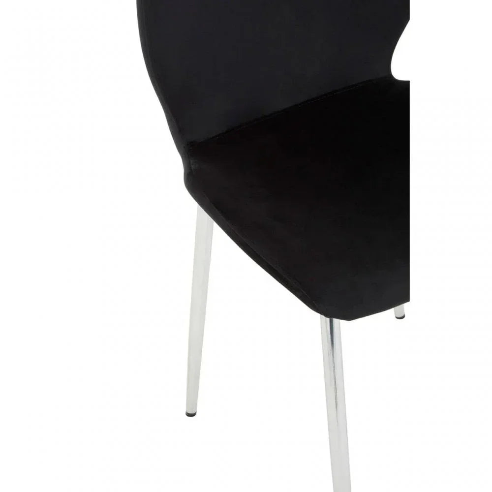 Black dining chair with chrome legs and curved seat, close-up view