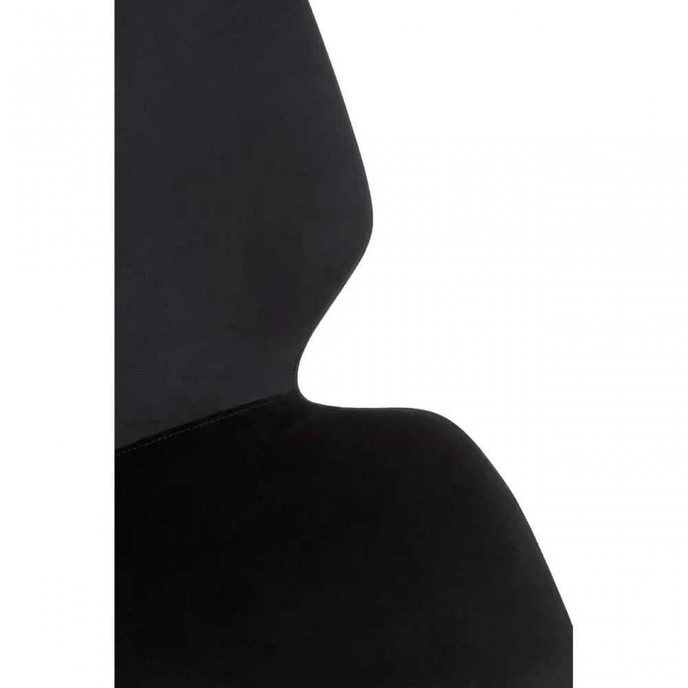 Closeup of black velvet dining chair backrest and seat with soft curved edges
