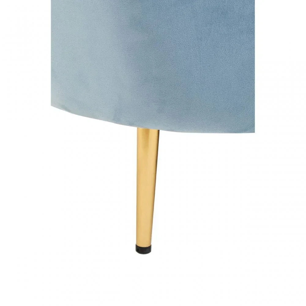 Blue velvet chair with gold metal leg close-up