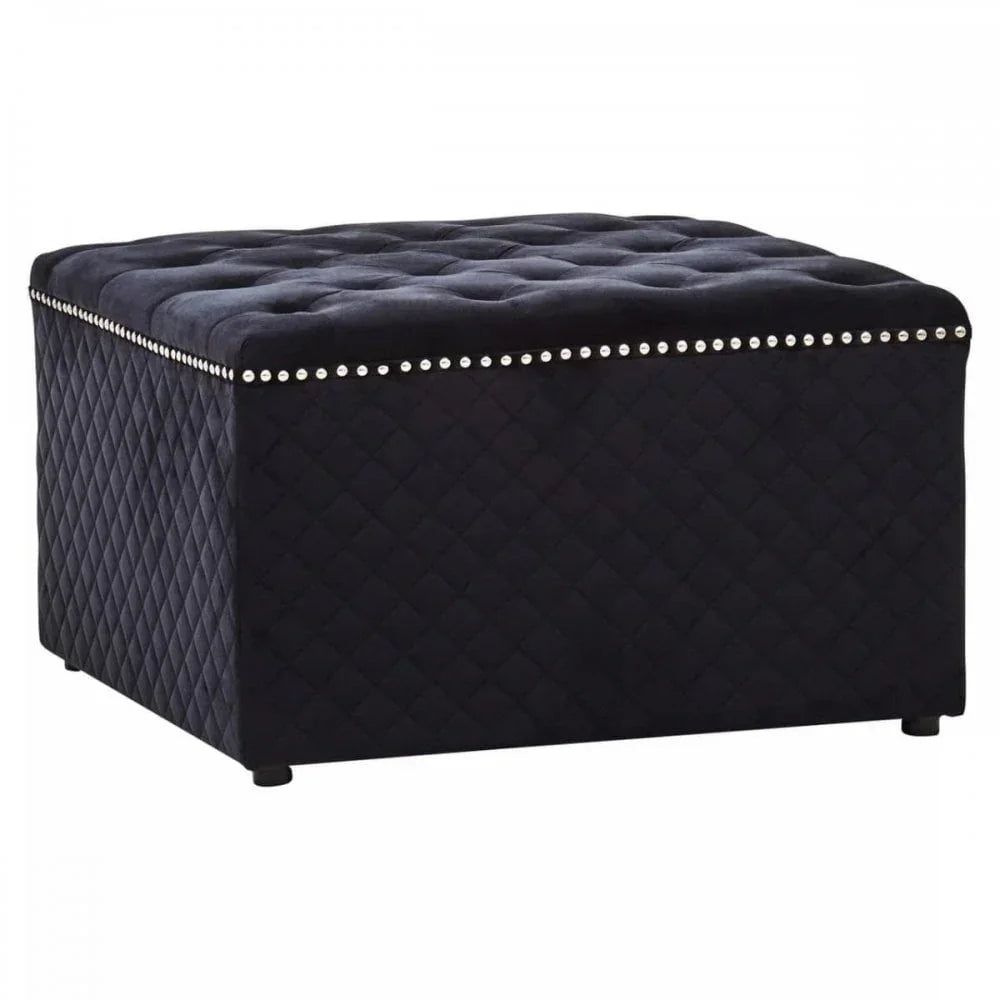 Black velvet ottoman with tufted top and silver stud detailing on quilted sides