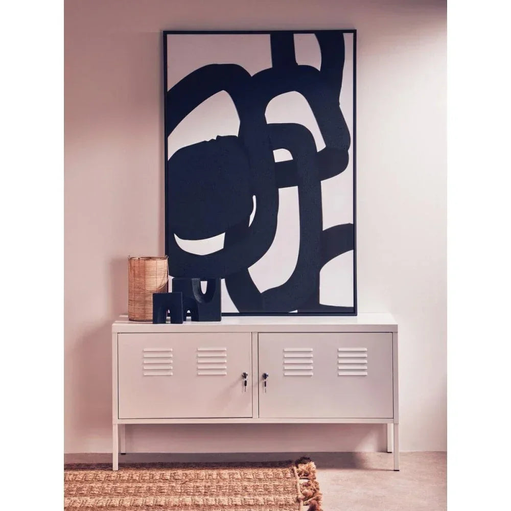White metal sideboard cabinet with black abstract wall art and decorative accents